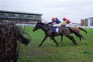 NEWBURY, ENGLAND - NOVEMBER 26: Harry Skelton riding Le Milos (orange cap) clear the last to win The Coral Gold Cup Handicap Chase at Newbury Racecourse on November 26, 2022 in Newbury, England. (Photo by Alan Crowhurst/Getty Images)