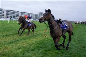 NEWBURY, ENGLAND - NOVEMBER 26: Harry Skelton riding Le Milos (orange cap) clear the last to win The Coral Gold Cup Handicap Chase at Newbury Racecourse on November 26, 2022 in Newbury, England. (Photo by Alan Crowhurst/Getty Images)