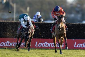 SUNBURY, ENGLAND - DECEMBER 26: Harry Cobden riding Bravemansgame (orange) clear the last to win The Ladbrokes King George VI Chase as Charlie Deutsch is unseated from L'Homme Presse at Kempton Park Racecourse on December 26, 2022 in Sunbury, England. (Photo by Alan Crowhurst/Getty Images)