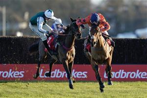 SUNBURY, ENGLAND - DECEMBER 26: Harry Cobden riding Bravemansgame (orange) clear the last to win The Ladbrokes King George VI Chase as Charlie Deutsch is unseated from L'Homme Presse at Kempton Park Racecourse on December 26, 2022 in Sunbury, England. (Photo by Alan Crowhurst/Getty Images)