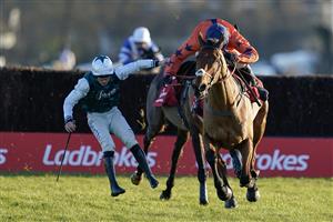 SUNBURY, ENGLAND - DECEMBER 26: Harry Cobden riding Bravemansgame (orange) clear the last to win The Ladbrokes King George VI Chase as Charlie Deutsch is unseated from L'Homme Presse at Kempton Park Racecourse on December 26, 2022 in Sunbury, England. (Photo by Alan Crowhurst/Getty Images)