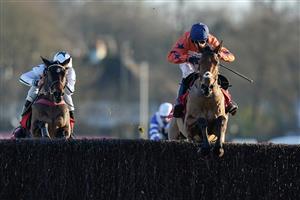 SUNBURY, ENGLAND - DECEMBER 26: Harry Cobden riding Bravemansgame (orange) clear the last to win The Ladbrokes King George VI Chase at Kempton Park Racecourse on December 26, 2022 in Sunbury, England. (Photo by Alan Crowhurst/Getty Images)