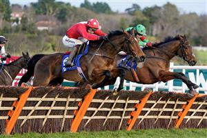 DUBLIN, IRELAND - DECEMBER 28: JJ Slevin riding Home By The Lee (red) clear the last to win The Jack De Bromhead Christmas Hurdle at Leopardstown Racecourse on December 28, 2022 in Dublin, Ireland. (Photo by Alan Crowhurst/Getty Images)
