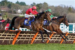 DUBLIN, IRELAND - DECEMBER 28: JJ Slevin riding Home By The Lee (red) clear the last to win The Jack De Bromhead Christmas Hurdle at Leopardstown Racecourse on December 28, 2022 in Dublin, Ireland. (Photo by Alan Crowhurst/Getty Images)