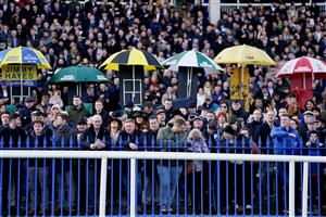 DUBLIN, IRELAND - DECEMBER 28: Racegoers watch the big screen at Leopardstown Racecourse on December 28, 2022 in Dublin, Ireland. (Photo by Alan Crowhurst/Getty Images)