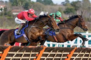 DUBLIN, IRELAND - DECEMBER 28: JJ Slevin riding Home By The Lee (red) clear the last to win The Jack De Bromhead Christmas Hurdle at Leopardstown Racecourse on December 28, 2022 in Dublin, Ireland. (Photo by Alan Crowhurst/Getty Images)