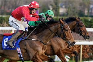 DUBLIN, IRELAND - DECEMBER 28: JJ Slevin riding Home By The Lee (red) clear the last to win The Jack De Bromhead Christmas Hurdle at Leopardstown Racecourse on December 28, 2022 in Dublin, Ireland. (Photo by Alan Crowhurst/Getty Images)