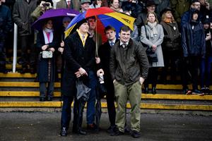 NEWBURY, ENGLAND - DECEMBER 31: Watching the racing as they shelter from the rain at Newbury Racecourse on December 31, 2022 in Newbury, England. (Photo by Alan Crowhurst/Getty Images)