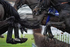 NEWBURY, ENGLAND - DECEMBER 31: Over the water jump during The Coral First For Horse Racing Handicap Chase at Newbury Racecourse on December 31, 2022 in Newbury, England. (Photo by Alan Crowhurst/Getty Images)