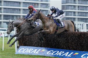 NEWBURY, ENGLAND - DECEMBER 31: Bryan Carver riding Grumpy Charley (L) clear the last to win The Coral Racing Club Mandarin Handicap Chase at Newbury Racecourse on December 31, 2022 in Newbury, England. (Photo by Alan Crowhurst/Getty Images)