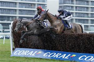 NEWBURY, ENGLAND - DECEMBER 31: Bryan Carver riding Grumpy Charley (L) clear the last to win The Coral Racing Club Mandarin Handicap Chase at Newbury Racecourse on December 31, 2022 in Newbury, England. (Photo by Alan Crowhurst/Getty Images)