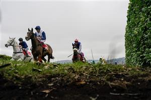 CHELTENHAM, ENGLAND - JANUARY 28: Sean Bowen riding Back On The Lash (red/white cap) before going on to win The Glenfarclas Cross Country Handicap Chase at Cheltenham Racecourse on January 28, 2023 in Cheltenham, England. (Photo by Alan Crowhurst/Getty Images)