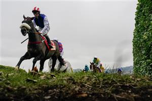 CHELTENHAM, ENGLAND - JANUARY 28: Sean Bowen riding Back On The Lash (red/white cap) before going on to win The Glenfarclas Cross Country Handicap Chase at Cheltenham Racecourse on January 28, 2023 in Cheltenham, England. (Photo by Alan Crowhurst/Getty Images)