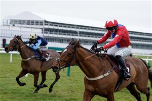 CHELTENHAM, ENGLAND - JANUARY 28: Niall Houlihan riding Editeur Du Gite (red) clear the last to win The Albert Bartlett Clarence House Chase at Cheltenham Racecourse on January 28, 2023 in Cheltenham, England. (Photo by Alan Crowhurst/Getty Images)
