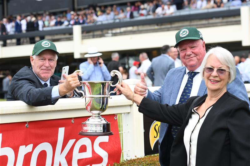 MELBOURNE, AUSTRALIA - FEBRUARY 25: Former part owner Allan Endresz gets to hold the winning trophy from the members lawn with Jeff and Robyn Simpson after Alligator Blood won Race 8, the Lamaro's Futurity Stakes, during Melbourne Racing at Sandown Lakeside on February 25, 2023 in Melbourne, Australia. (Getty)