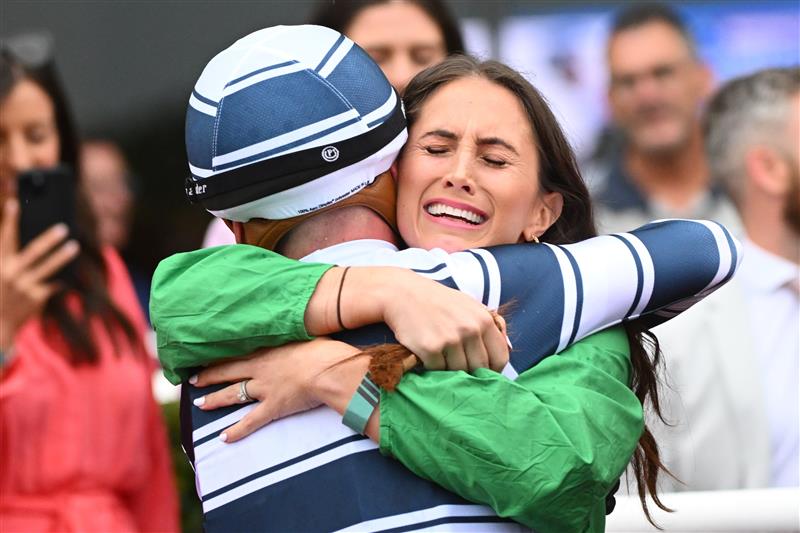 MELBOURNE, AUSTRALIA - FEBRUARY 25: Caitlin Hoysted hugs  Ben Thompson after he won aboard Uncommon James in Race 9, the Ladbrokes Oakleigh Plate,  during Melbourne Racing at Sandown Lakeside on February 25, 2023 in Melbourne, Australia. (Photo by Vince Caligiuri/Getty Images)