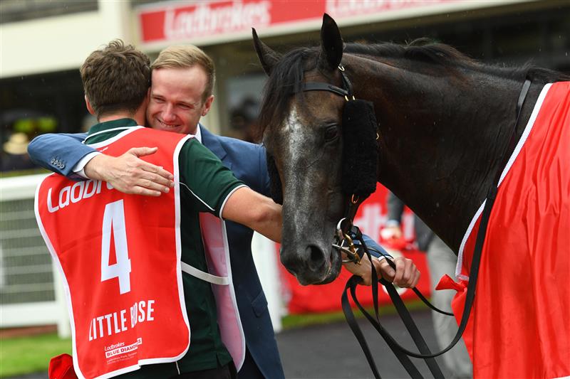 MELBOURNE, AUSTRALIA - FEBRUARY 25: Trainer JD Hayes hugs strapper after Little Brose won Race 7, the Ladbrokes Blue Diamond Stakes,  during Melbourne Racing at Sandown Lakeside on February 25, 2023 in Melbourne, Australia. (Photo by Vince Caligiuri/Getty Images)