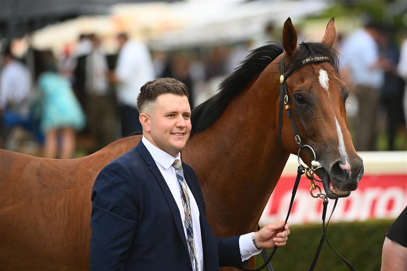 MELBOURNE, AUSTRALIA - FEBRUARY 25: Trainer Matthew Hoysted poses with Uncommon James after winning Race 9, the Ladbrokes Oakleigh Plate,  during Melbourne Racing at Sandown Lakeside on February 25, 2023 in Melbourne, Australia. (Photo by Vince Caligiuri/Getty Images)