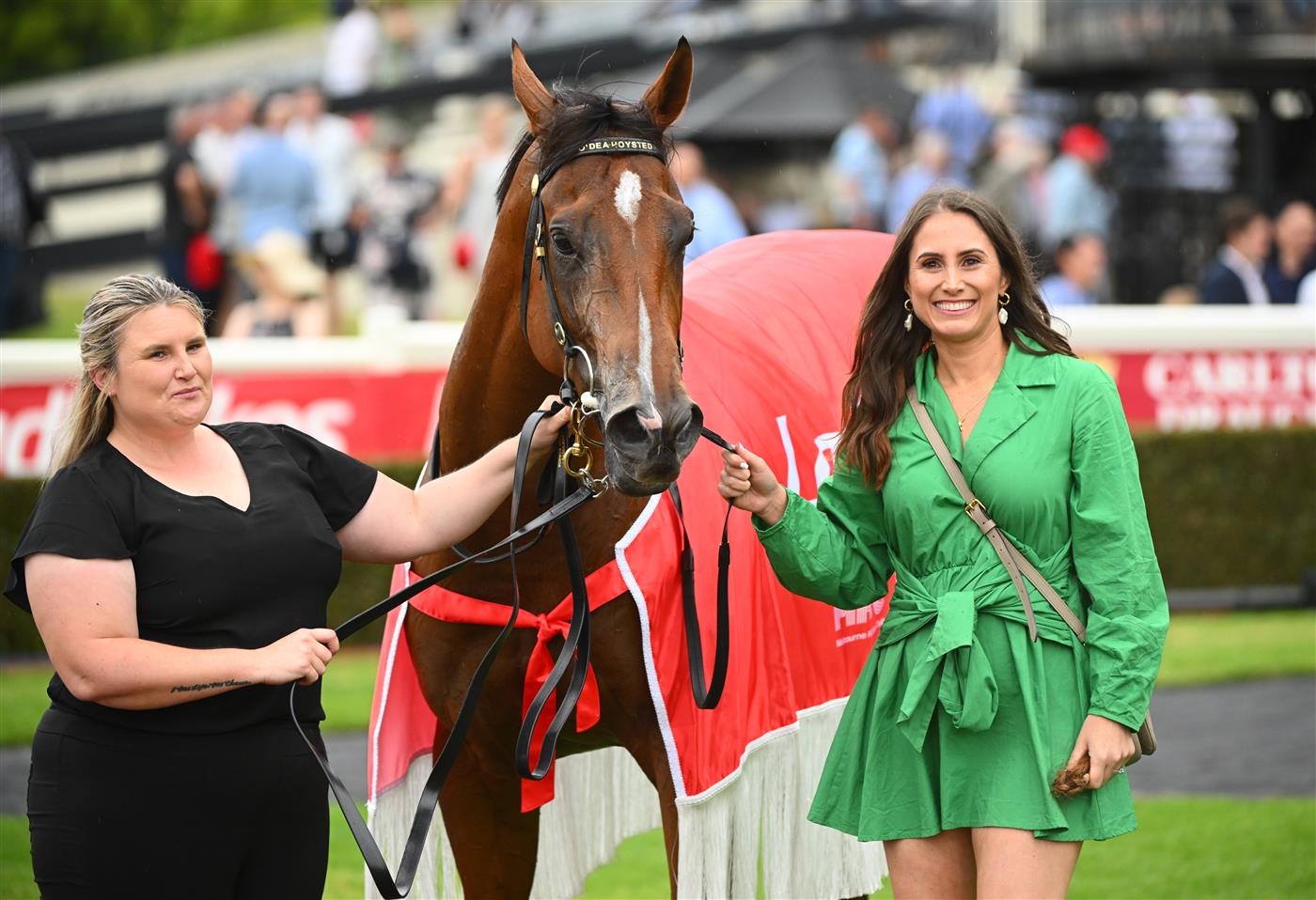 MELBOURNE, AUSTRALIA - FEBRUARY 25: Caitlin Hoysted (r) poses with Uncommon James after winning Race 9, the Ladbrokes Oakleigh Plate,  during Melbourne Racing at Sandown Lakeside on February 25, 2023 in Melbourne, Australia. (Photo by Vince Caligiuri/Getty Images)