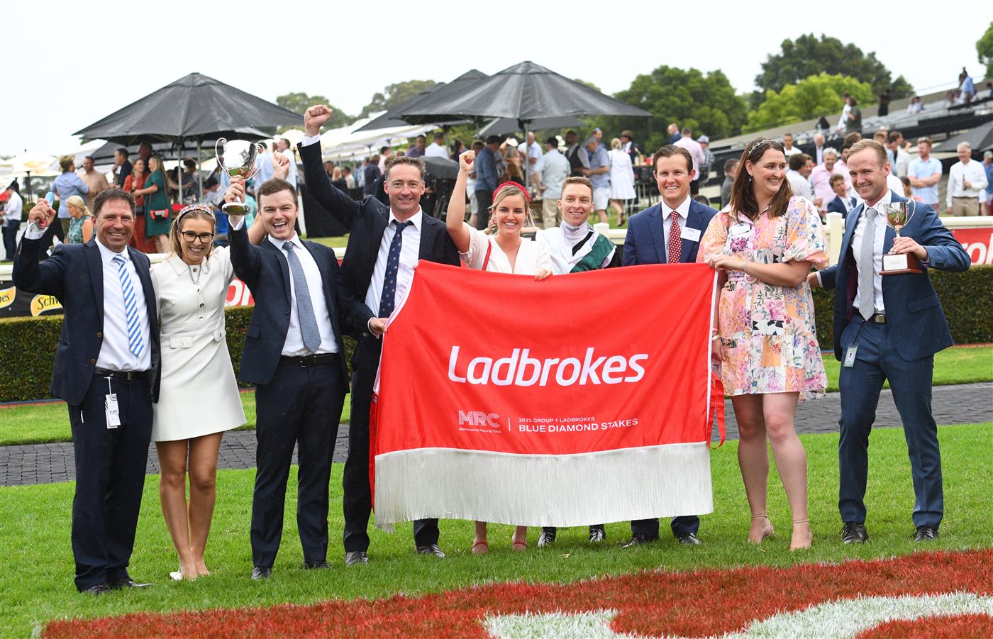 MELBOURNE, AUSTRALIA - FEBRUARY 25: Michael Dee poses with winning connections after riding Little Brose to win Race 7, the Ladbrokes Blue Diamond Stakes,  during Melbourne Racing at Sandown Lakeside on February 25, 2023 in Melbourne, Australia. (Photo by Vince Caligiuri/Getty Images)