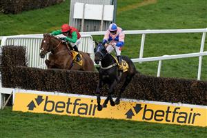 ESHER, ENGLAND - MARCH 11: Jamie Moore riding Hudson De Grugy (pink) clear the last to win The Betfair Daily Multiples Offer At Cheltenham Novices' Handicap Chase from Harry Cobden and Quel Destin at Sandown Park on March 11, 2023 in Esher, England. (Photo by Alan Crowhurst/Getty Images)