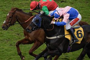 ESHER, ENGLAND - MARCH 11: Jamie Moore riding Hudson De Grugy (pink) clear the last to win The Betfair Daily Multiples Offer At Cheltenham Novices' Handicap Chase from Harry Cobden and Quel Destin at Sandown Park on March 11, 2023 in Esher, England. (Photo by Alan Crowhurst/Getty Images)
