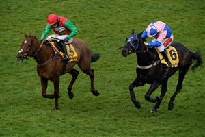 ESHER, ENGLAND - MARCH 11: Jamie Moore riding Hudson De Grugy (pink) clear the last to win The Betfair Daily Multiples Offer At Cheltenham Novices' Handicap Chase from Harry Cobden and Quel Destin at Sandown Park on March 11, 2023 in Esher, England. (Photo by Alan Crowhurst/Getty Images)