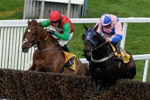 ESHER, ENGLAND - MARCH 11: Jamie Moore riding Hudson De Grugy (pink) clear the last to win The Betfair Daily Multiples Offer At Cheltenham Novices' Handicap Chase from Harry Cobden and Quel Destin at Sandown Park on March 11, 2023 in Esher, England. (Photo by Alan Crowhurst/Getty Images)