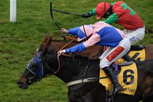 ESHER, ENGLAND - MARCH 11: Jamie Moore riding Hudson De Grugy (pink) clear the last to win The Betfair Daily Multiples Offer At Cheltenham Novices' Handicap Chase from Harry Cobden and Quel Destin at Sandown Park on March 11, 2023 in Esher, England. (Photo by Alan Crowhurst/Getty Images)
