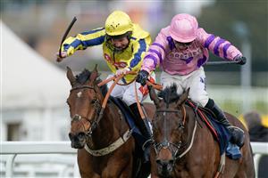 ESHER, ENGLAND - MARCH 11: Connor Brace riding Crambo (pink) clear the last to win The European Breeders' Fund Betfair 'National Hunt' Novices' Handicap Hurdle Final from Jamie Moore and Inneston (L) at Sandown Park on March 11, 2023 in Esher, England. (Photo by Alan Crowhurst/Getty Images)