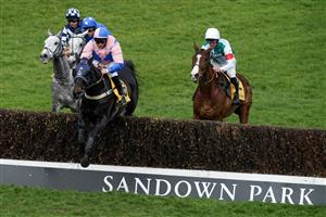 ESHER, ENGLAND - MARCH 11: Jamie Moore riding Hudson De Grugy (pink) on their way to winning The Betfair Daily Multiples Offer At Cheltenham Novices' Handicap Chase from Harry Cobden and Quel Destin at Sandown Park on March 11, 2023 in Esher, England. (Photo by Alan Crowhurst/Getty Images)