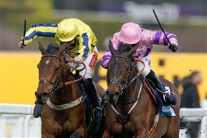 ESHER, ENGLAND - MARCH 11: Connor Brace riding Crambo (pink) clear the last to win The European Breeders' Fund Betfair 'National Hunt' Novices' Handicap Hurdle Final from Jamie Moore and Inneston (L) at Sandown Park on March 11, 2023 in Esher, England. (Photo by Alan Crowhurst/Getty Images)