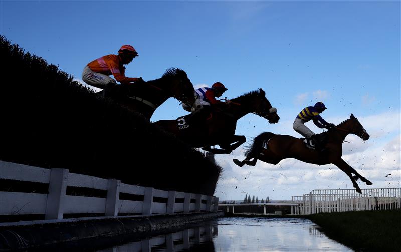 CHELTENHAM, ENGLAND - MARCH 14: Runners take the water jump during the Ultima Handicap Chase during day one of the Cheltenham Festival 2023 at Cheltenham Racecourse on March 14, 2023 in Cheltenham, England. (Photo by Michael Steele/Getty Images)