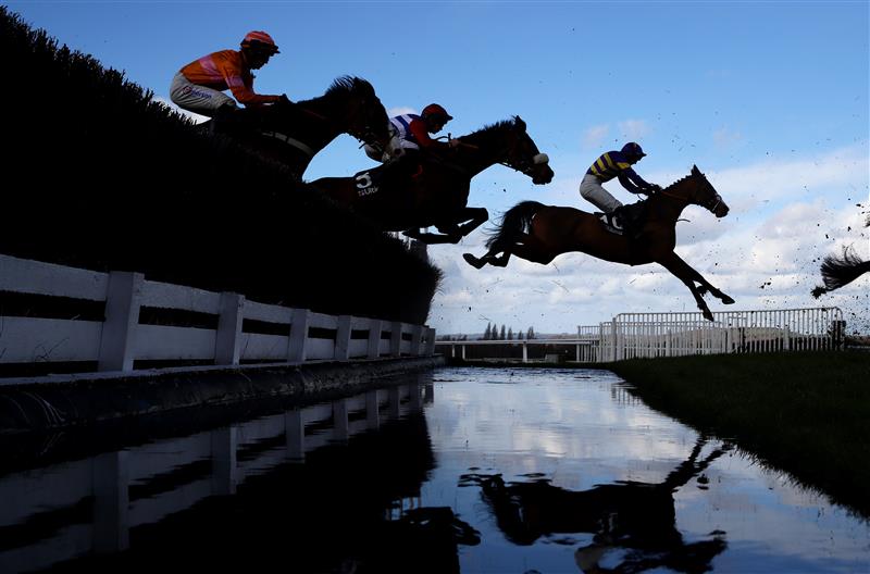 CHELTENHAM, ENGLAND - MARCH 14: Runners take the water jump during the Ultima Handicap Chase during day one of the Cheltenham Festival 2023 at Cheltenham Racecourse on March 14, 2023 in Cheltenham, England. (Photo by Michael Steele/Getty Images)