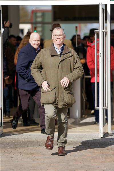 CHELTENHAM, ENGLAND - MARCH 14: The first racegoer through the gates runs to find the best spot during day one of the Cheltenham Festival 2023 at Cheltenham Racecourse on March 14, 2023 in Cheltenham, England. (Photo by Alan Crowhurst/Getty Images)