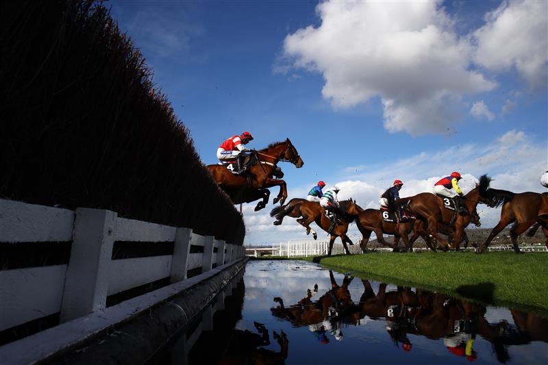 CHELTENHAM, ENGLAND - MARCH 14: Runners take the water jump during the Ultima Handicap Chase during day one of the Cheltenham Festival 2023 at Cheltenham Racecourse on March 14, 2023 in Cheltenham, England. (Photo by Michael Steele/Getty Images)
