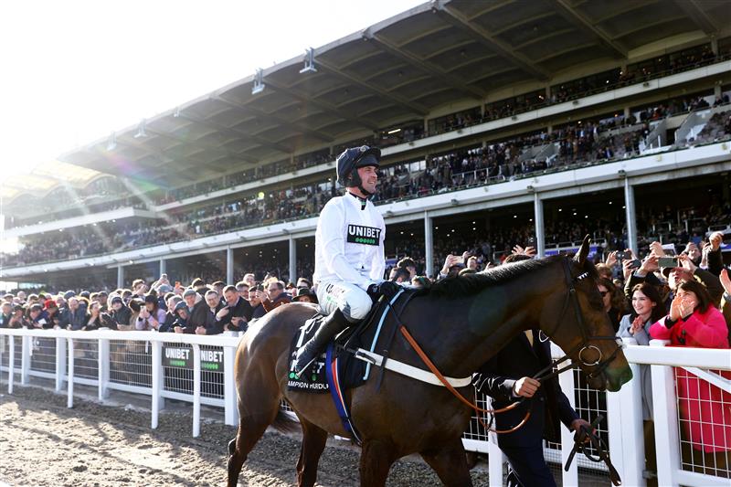 CHELTENHAM, ENGLAND - MARCH 14: Nico de Boinville celebrates on board Constitution Hill after winning the the Unibet Champion Hurdle Challenge Trophy during day one of the Cheltenham Festival 2023 at Cheltenham Racecourse on March 14, 2023 in Cheltenham, England. (Photo by Michael Steele/Getty Images)