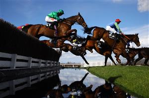 CHELTENHAM, ENGLAND - MARCH 14: Runners take the water jump during the Ultima Handicap Chase during day one of the Cheltenham Festival 2023 at Cheltenham Racecourse on March 14, 2023 in Cheltenham, England. (Photo by Michael Steele/Getty Images)