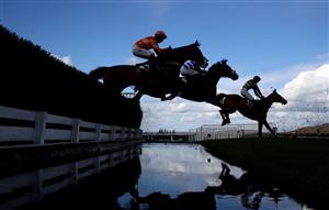 CHELTENHAM, ENGLAND - MARCH 14: Runners take the water jump during the Ultima Handicap Chase during day one of the Cheltenham Festival 2023 at Cheltenham Racecourse on March 14, 2023 in Cheltenham, England. (Photo by Michael Steele/Getty Images)