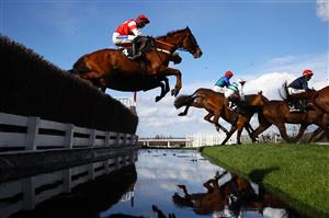 CHELTENHAM, ENGLAND - MARCH 14: Runners take the water jump during the Ultima Handicap Chase during day one of the Cheltenham Festival 2023 at Cheltenham Racecourse on March 14, 2023 in Cheltenham, England. (Photo by Michael Steele/Getty Images)