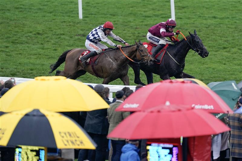 CHELTENHAM, ENGLAND - MARCH 15: Keith Donoghue riding Delta Work (maroon) approach the last before winning The Glenfarclas Chase from Davy Russell and Galvin during day two of the Cheltenham Festival 2023 at Cheltenham Racecourse on March 15, 2023 in Cheltenham, England. (Photo by Alan Crowhurst/Getty Images)