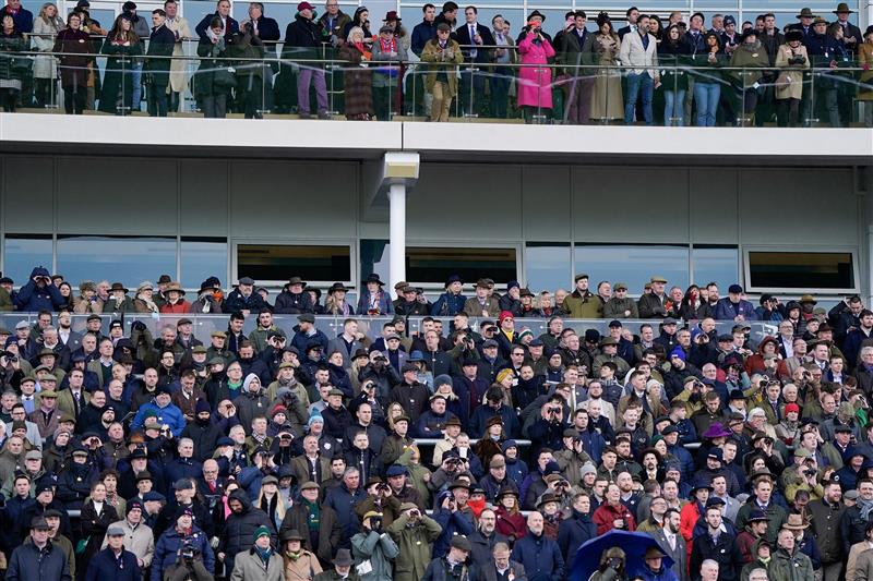 CHELTENHAM, ENGLAND - MARCH 15: Racegoers watch the action during day two of the Cheltenham Festival 2023 at Cheltenham Racecourse on March 15, 2023 in Cheltenham, England. (Photo by Alan Crowhurst/Getty Images)