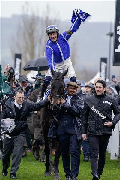 CHELTENHAM, ENGLAND - MARCH 15: Paul Townend riding Energumene return with owner Tony Bloom (L) after winning The Betway Queen Mother Champion Chase during day two of the Cheltenham Festival 2023 at Cheltenham Racecourse on March 15, 2023 in Cheltenham, England. (Photo by Alan Crowhurst/Getty Images)