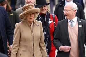 CHELTENHAM, ENGLAND - MARCH 15: Camilla, Queen Consort talks to Ian Renton, Managing Director of Cheltenham Racecourse as she arrives at day two of the Cheltenham Festival 2023 at Cheltenham Racecourse on March 15, 2023 in Cheltenham, England. (Photo by Michael Steele/Getty Images)