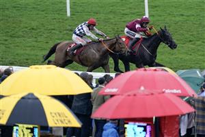 CHELTENHAM, ENGLAND - MARCH 15: Keith Donoghue riding Delta Work (maroon) approach the last before winning The Glenfarclas Chase from Davy Russell and Galvin during day two of the Cheltenham Festival 2023 at Cheltenham Racecourse on March 15, 2023 in Cheltenham, England. (Photo by Alan Crowhurst/Getty Images)