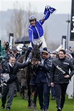 CHELTENHAM, ENGLAND - MARCH 15: Paul Townend riding Energumene return with owner Tony Bloom (L) after winning The Betway Queen Mother Champion Chase during day two of the Cheltenham Festival 2023 at Cheltenham Racecourse on March 15, 2023 in Cheltenham, England. (Photo by Alan Crowhurst/Getty Images)