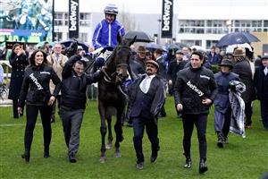 CHELTENHAM, ENGLAND - MARCH 15: Paul Townend riding Energumene return with owner Tony Bloom (L) after winning The Betway Queen Mother Champion Chase during day two of the Cheltenham Festival 2023 at Cheltenham Racecourse on March 15, 2023 in Cheltenham, England. (Photo by Alan Crowhurst/Getty Images)