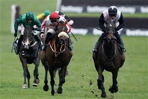 CHELTENHAM, ENGLAND - MARCH 15: Sam Twiston-Davies riding The Real Whacker (red/white) clear the last to win The Brown Advisory Novices' Chase during day two of the Cheltenham Festival 2023 at Cheltenham Racecourse on March 15, 2023 in Cheltenham, England. (Photo by Alan Crowhurst/Getty Images)