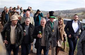 CHELTENHAM, ENGLAND - MARCH 17: Racegoers arrive ahead of day four of the Cheltenham Festival 2023 at Cheltenham Racecourse on March 17, 2023 in Cheltenham, England. (Photo by Ryan Pierse/Getty Images)