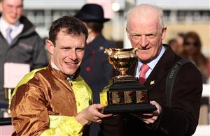 CHELTENHAM, ENGLAND - MARCH 17: Paul Townend poses alongside Trainer Willie Mullins after winning the Boodles Cheltenham Gold Cup Chase on board Galopin Des Champs during day four of the Cheltenham Festival 2023 at Cheltenham Racecourse on March 17, 2023 in Cheltenham, England. (Photo by Ryan Pierse/Getty Images)